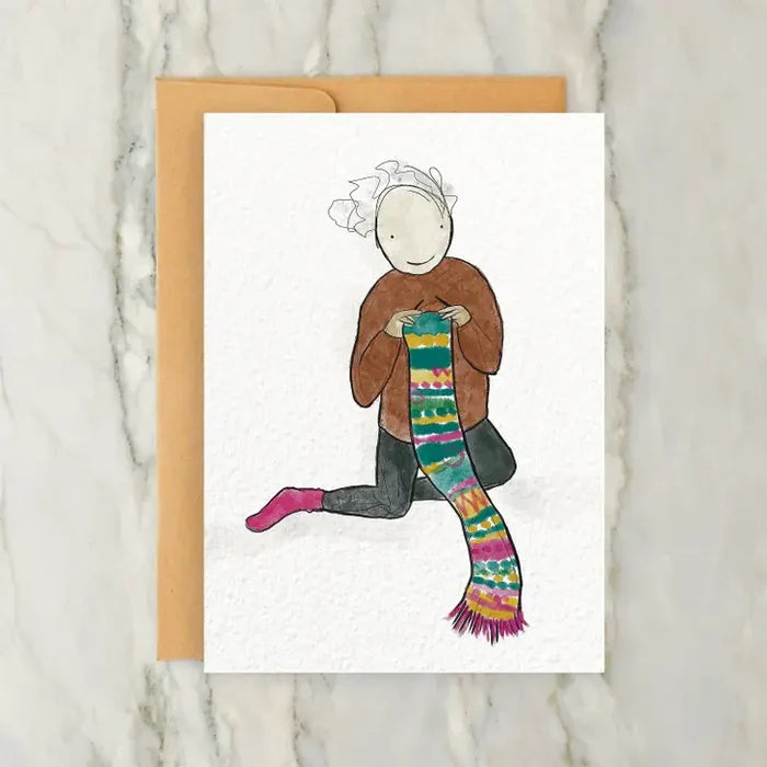Person Knitting a Long Scarf
