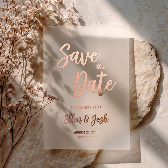XOXOKristen vellum Save the Date card printed in rose gold foil, styled on natural stone with dried floral accents and soft sunlight for a romantic modern aesthetic – XOXOKristen.